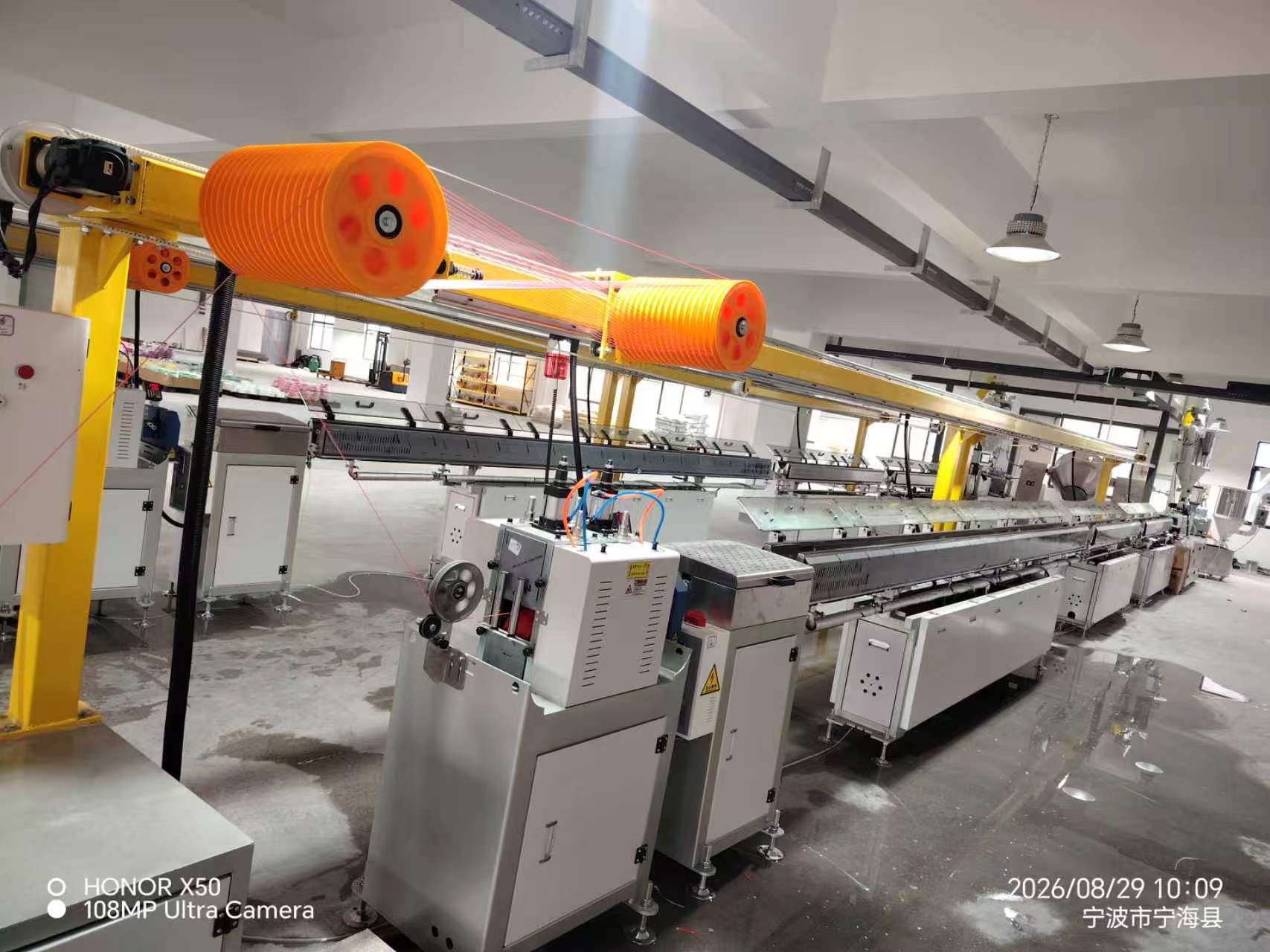 Close-up of filament spooling equipment on the production line